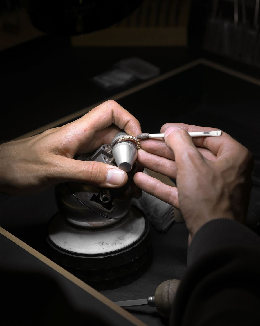 Hands finishing a ring at the workbench